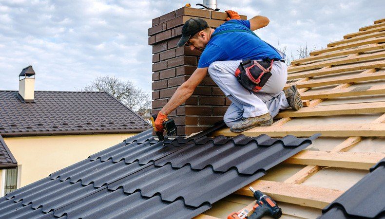 Roofing crew replacing hail-damaged shingles on a Colorado home