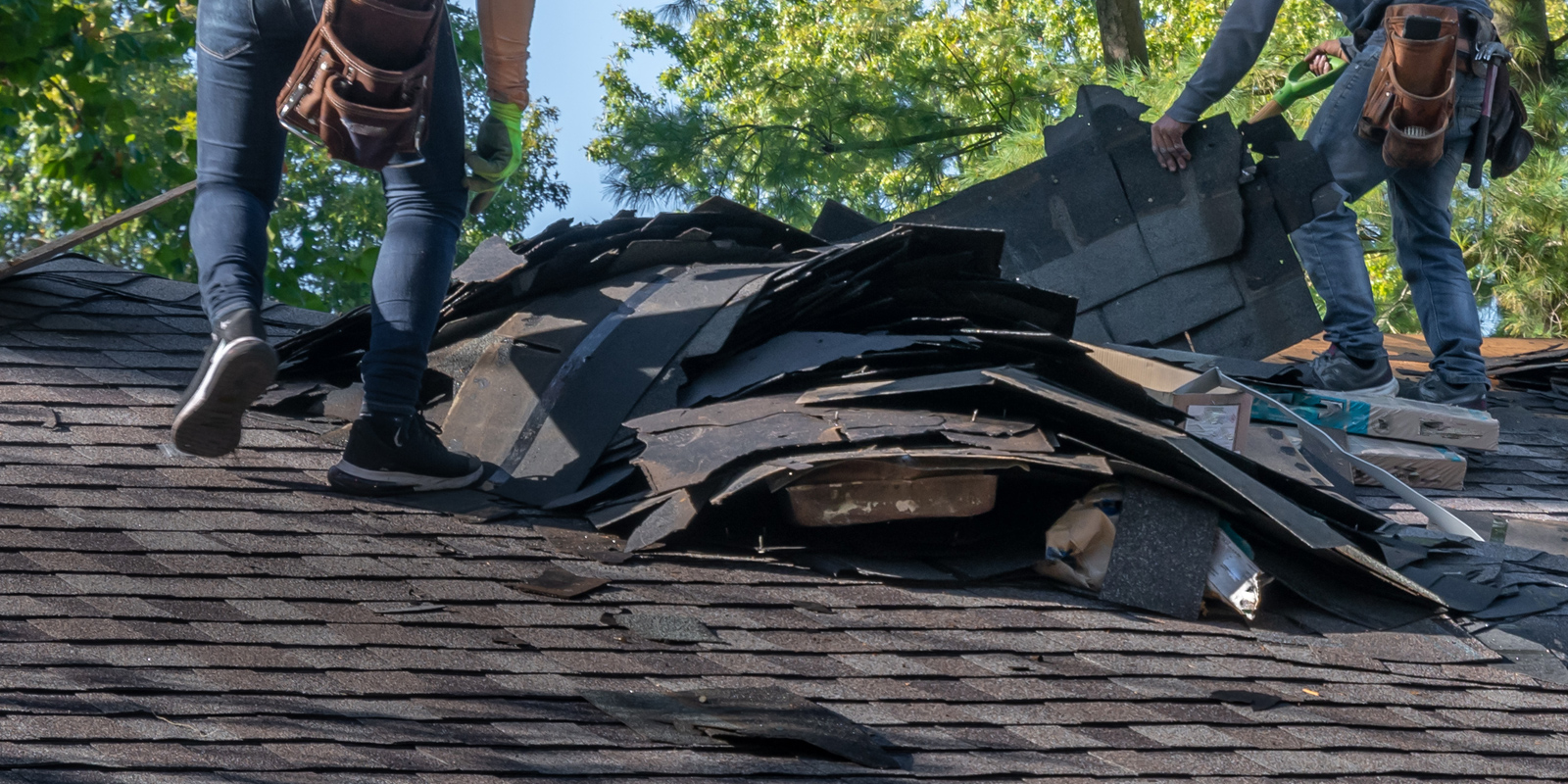 Roofing professional inspecting Colorado roof after hail damage